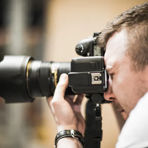 Photographer shooting with a telephoto lens during a golf trip