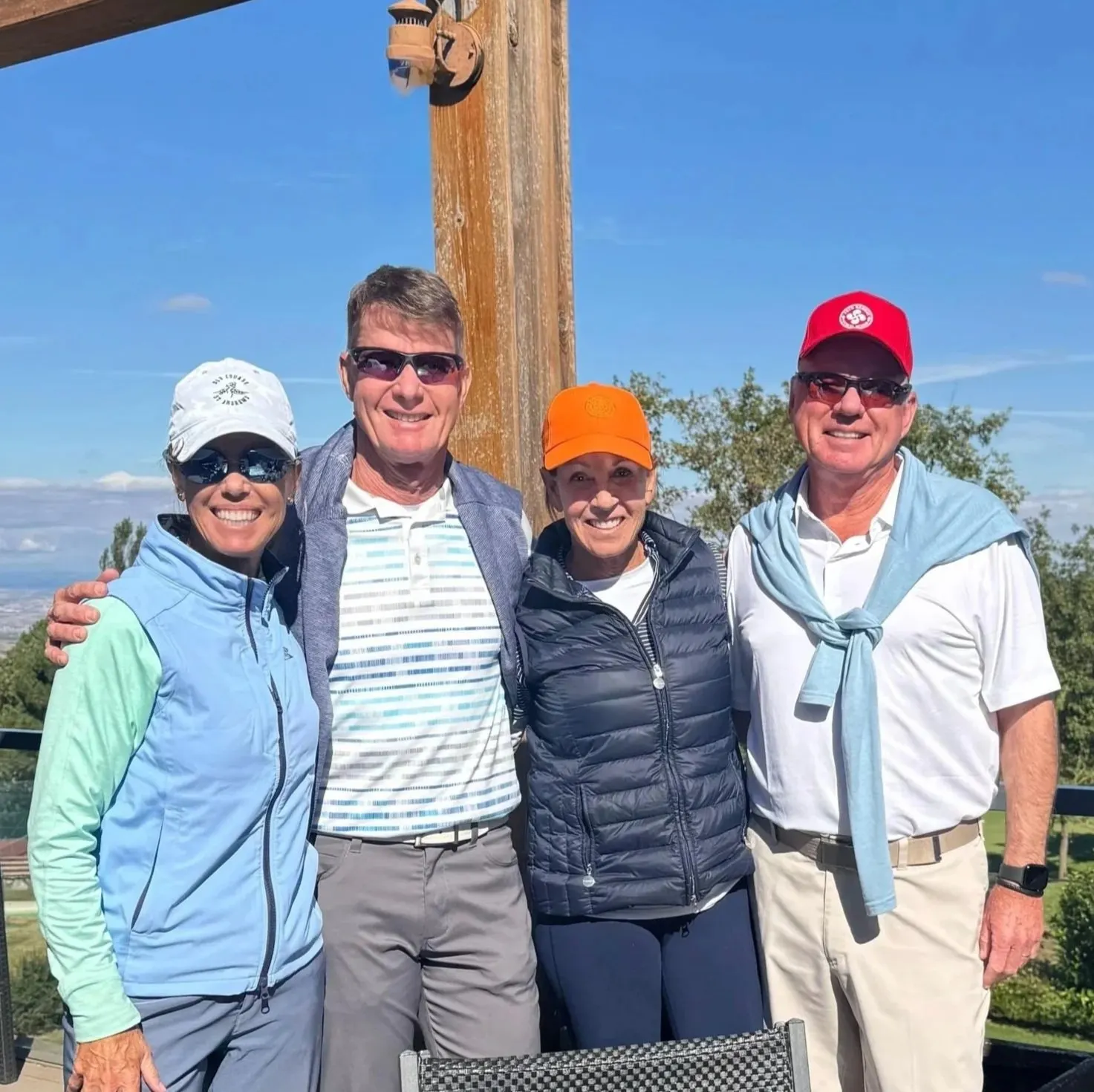 Aileen's group of four holding their clubs on a golf course in Madrid